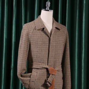 A full-length, straight-silhouette trench coat in army green plaid wool featuring raglan sleeves, a turn-down collar, an unexposed closure, and a belted waist.