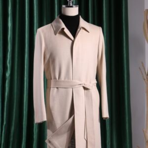 A full-length, slim-fit single-breasted trench coat in beige cashmere-silk blend featuring an unexposed front closure, a belted waist, and a clean, elegant silhouette.
