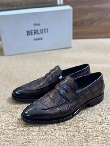 Side profile of Berluti alligator loafers showing the distinct scale texture and hand-painted brown patina.