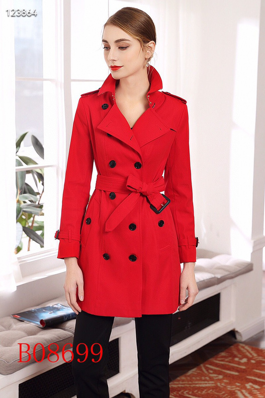 Women's vibrant red double-breasted trench coat with self-tie belt and black buttons, featuring classic collar, epaulets, and back view detail.