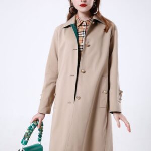 A midi-length, beltless single-breasted cotton coat in a straight-cut silhouette featuring raglan sleeves, a turn-down collar, and prominent metal buttons.