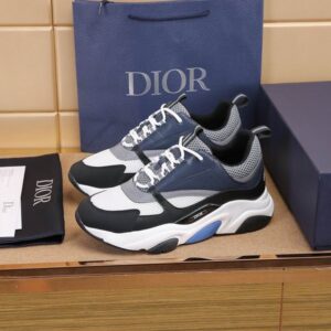 A pair of Dior B22 Blue, Black, and White Technical Mesh Sneakers displayed with a blue Dior box and dust bag, showing the white mesh and blue leather overlays.