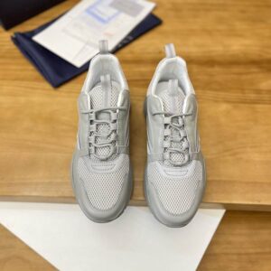 A pair of Dior B24 Cannage Motif Sneakers in Light Grey Mesh and Leather, showing the signature Cannage motif and drawstring laces.