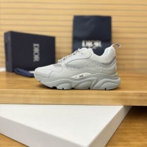 side views of DIOR B24 sneakers in light grey technical mesh and leather with a thick, sculpted grey rubber sole.