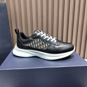 white DIOR B27 low-top sneakers with black and white Oblique canvas side panels displayed on a glass surface with luxury packaging.