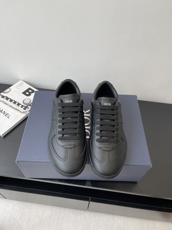 A pair of Dior B27 Low-Top Sneakers in Triple Black Smooth Calfskin, showcasing the tonal black leather and the signature Oblique Galaxy side panels.