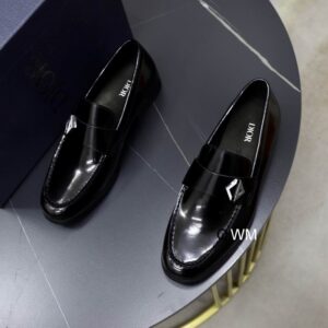 A top-down view of DIOR Midnight Galaxy Patina Leather Loafers in electric blue and black, showcasing the glossy gradient finish on a grey marble tabletop.