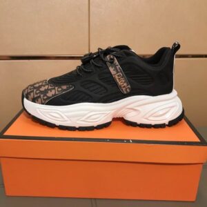 A side profile view of a black DIOR Vibe sneaker with brown Oblique monogram patterns on the toe and a white MISS DIOR logo band across the tongue.