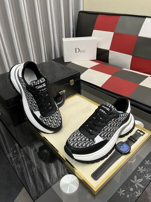 A side-profile view of a chunky luxury sneaker featuring black and white monogrammed canvas, black leather overlays, and a thick, wavy white and grey midsole.