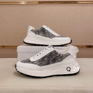 Side view of Dior B24 Low-Top Sneaker in White and Grey Oblique Canvas sitting on a white brand box.