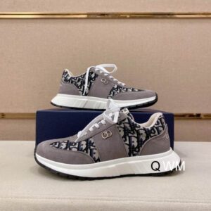 Side profile of Dior B25 Runner sneakers featuring grey suede panels, black Oblique monogram canvas, white laces, and a white rubber sole.