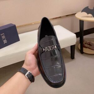 Dior Black Croc-Embossed Leather Buckle Loafer with a textured crocodile pattern and silver metal hardware displayed on a blue box.