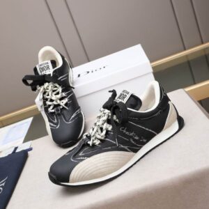 A close-up view of the Dior Chrono low-top sneaker featuring gold-tone Dior Oblique fabric, white leather panels, and a chunky white sculptural midsole.