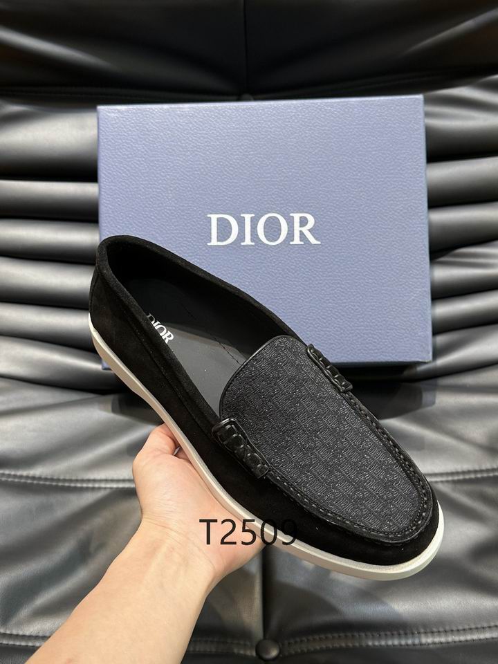 Overhead view of DIOR Granville Loafers in black suede with black Oblique jacquard inserts next to a blue DIOR branded box.