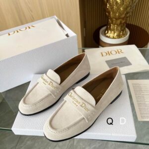 pair of Dior Granville Loafers in Beige Suede with gold-tone "Christian Dior Paris" embroidery on the straps, displayed on a white branded box