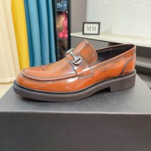 Side view of DIOR Heritage Horsebit Patina Leather Loafers in mahogany brown resting on a black designer shoe box.