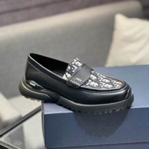 Dior-Oblique Canvas Penny Loafers in Midnight Black displayed on a navy blue box, showcasing the patterned canvas and thick rubber soles.