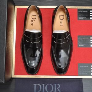 Dior Polished Black Leather Classic Penny Loafer with embossed branding on the strap and a tan leather interior.