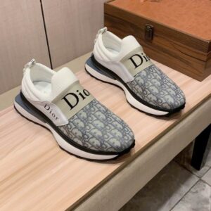 Pair of Dior Vibe Slip-On Sneakers in Dior Oblique featuring a "DIOR" elastic band and a white rubber sole.