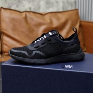 Triple Black Dior B27 sneakers on a grey marble table, featuring black mesh uppers and white Dior Oblique monogram patterns on the side panels.