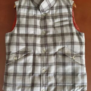 horizontal quilted duck-down vest with a stand collar, button-up front featuring horn buttons, one chest pocket, and two large flap pockets.