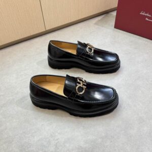 Front view of a charcoal grey Moncler Cardere hooded puffer jacket with a matte finish, shown flat on a grey tile floor with visible down quilting