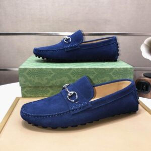 Profile view of a royal blue suede driving moccasin with silver horsebit hardware on a neutral background.