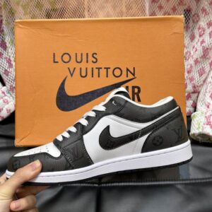 Single Black and White Monogram print street sneaker held up, showing the side profile and classic logo style against an orange box.