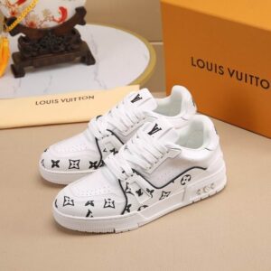 Pair of LV Trainer style sneakers in white leather with black Monogram patterns and a thick white sole, next to an orange luxury shoe box.