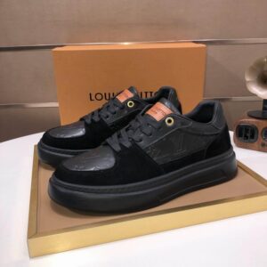 A pair of black Louis Vuitton Beverly Hills sneakers with embossed monogram leather and gold-tone eyelets on a display tray.