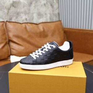 black low-top sneakers with an embossed checkered pattern, white laces, white heel, and a thick white rubber sole, inspired by Louis Vuitton designs