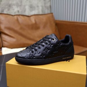 all-black low-top sneakers featuring an embossed Louis Vuitton-inspired monogram pattern, black laces, black eyelets, and a black rubber sole, presented .
