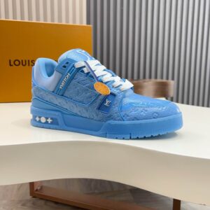 Side profile of a single light blue Louis Vuitton-inspired trainer, highlighting the sculpted blue sole and the debossed VUITTON strap detail.