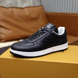 Black Synthetic Leather Low Top Sneakers with perforated Monogram details, prominent white sole, and black laces, displayed