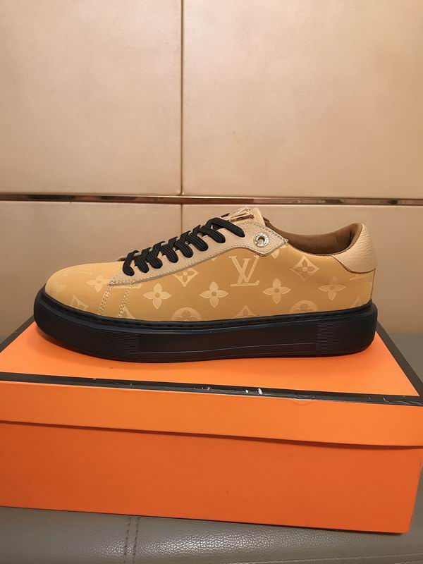 beige low-top sneakers with an all-over Louis Vuitton-inspired monogram pattern, featuring black laces, a prominent black platform sole, and a tan lining.