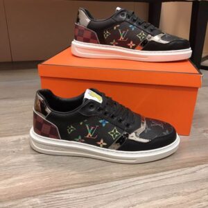 Louis Vuitton Monogram Trainer Low sneaker in brown and black, featuring classic Monogram canvas, black leather, mirrored silver accent, checkered heel, and a white rubber sole.