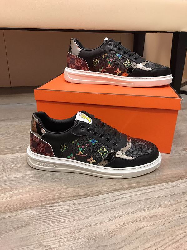 Louis Vuitton Monogram Trainer Low sneaker in brown and black, featuring classic Monogram canvas, black leather, mirrored silver accent, checkered heel, and a white rubber sole.