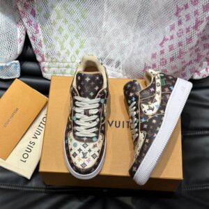 Louis Vuitton Monogram Trainer Low sneaker in brown, fully covered in multicolor Monogram print, with white laces and a white rubber sole.