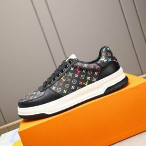Black low-top sneaker featuring a multicolor Louis Vuitton inspired monogram pattern, white midsole, and black laces; luxury-inspired fashion footwear.
