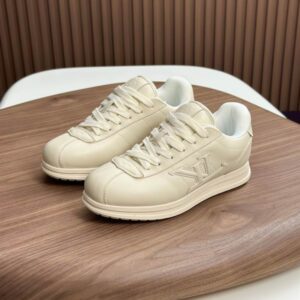 Monochrome cream beige leather low-top sneaker with a debossed side logo, inspired by the Louis Vuitton Run Away silhouette.