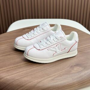 White leather low-top sneaker inspired by Louis Vuitton Run Away with red piping, white laces, and a red-trimmed side logo.