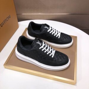 Black Louis Vuitton Stellar-style low-top sneaker, embossed Monogram pattern on black leather, white laces, thick white rubber outsole, "LV" logo, designer inspired.