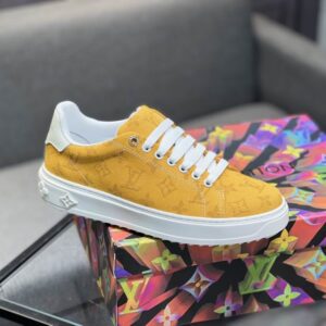 Yellow Louis Vuitton Stellar-style low-top sneaker, embossed Monogram pattern on canvas, thick white sole, white laces, designer inspired.