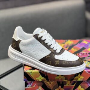 Louis Vuitton inspired low-top trainer, brown monogram leather, white perforated leather, gold LV logo on tongue, classic colorway.
