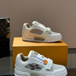 Louis Vuitton Trainer Strap Sneaker in off-white, light gray, and brown, featuring a velcro strap, brown Monogram flower logo, and a chunky white rubber outsole.