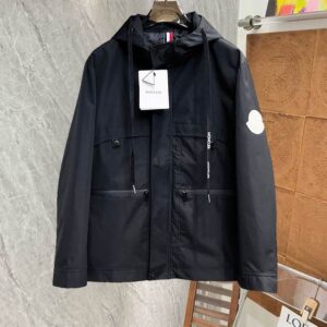 Black/White Color Block Windbreaker: Back view of the Black and White athletic color-block jacket, showcasing the hood and curved panel design.