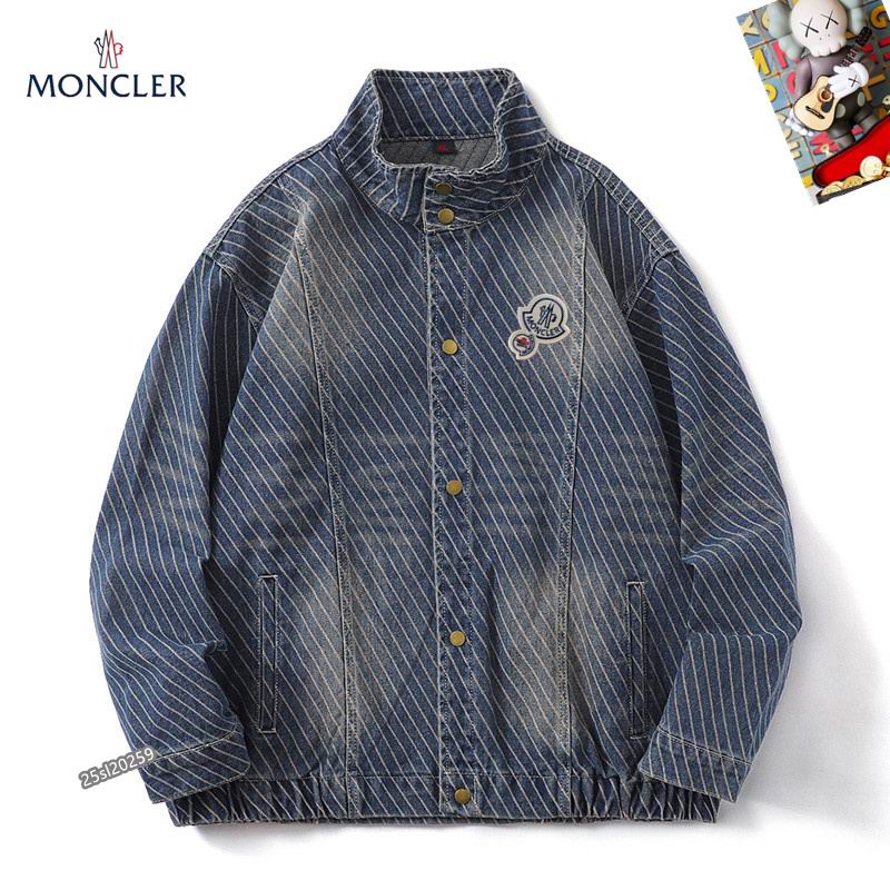 Moncler-style blue denim jacket with diagonal white stripes, a stand collar, and gold-tone snap-button closures over a central zipper. Features a circular logo patch on the chest.