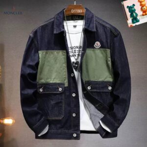 Image of a dark blue denim jacket with a contrasting olive green rectangular panel across the chest. The jacket has a collar, button closures, and two patch pockets on the chest and two on the waist.