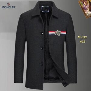 Men's charcoal gray Moncler-style short wool-blend coat with black faux fur lining, tricolor stripe chest trim, and an embroidered logo patch, displayed on a hanger.
