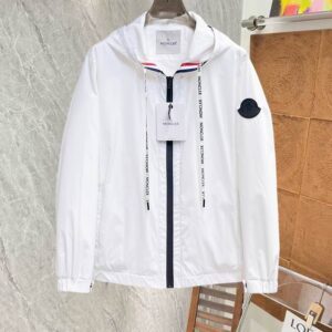 Close-up image of a black technical windbreaker jacket with an adjustable hood, a zipper closure, and a large white stylized rooster graphic logo printed on the left chest